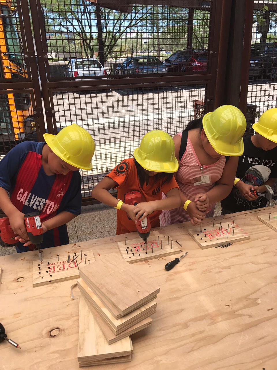 Group of kids drilling in screws
