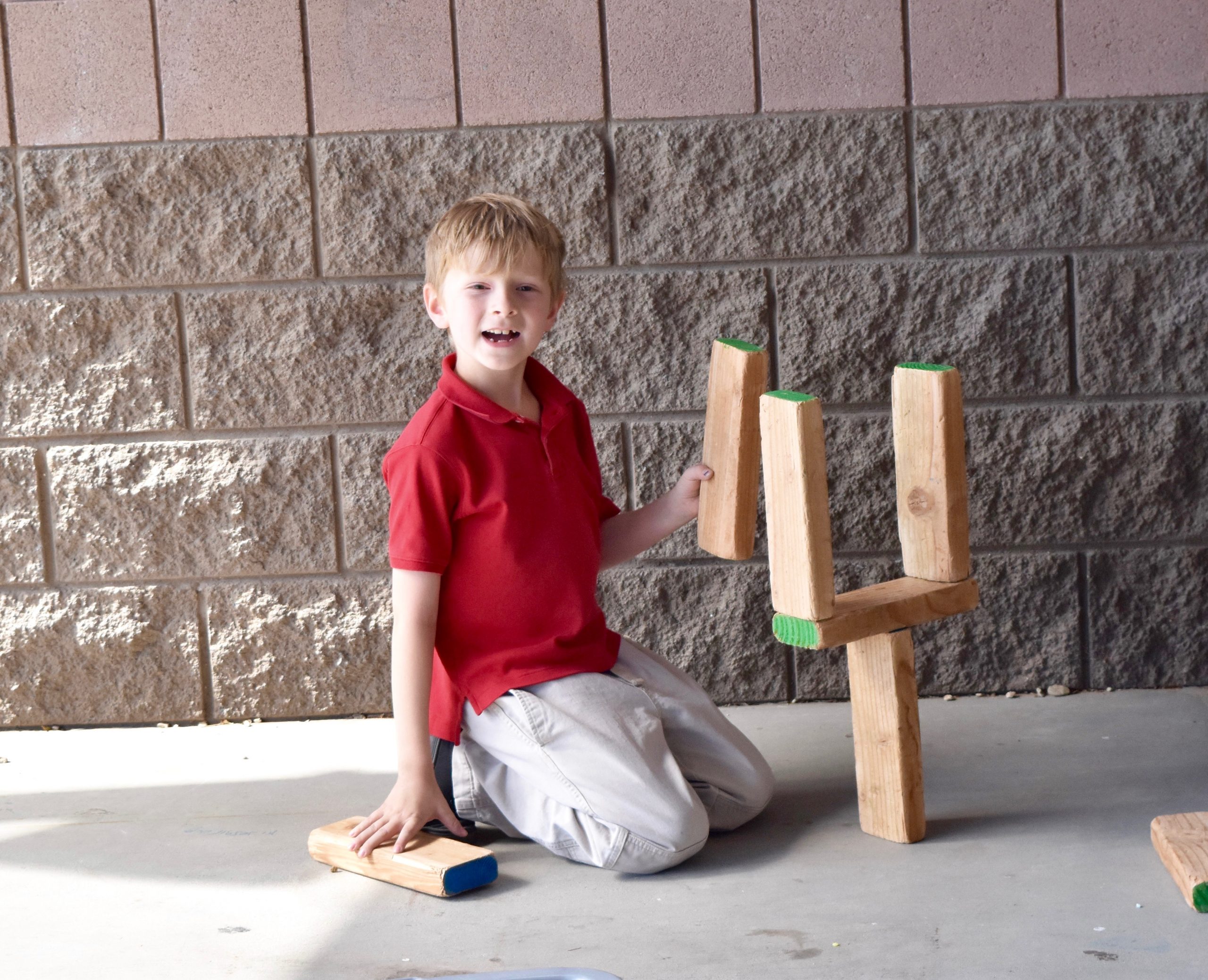 Young boy playing with wooden blocks